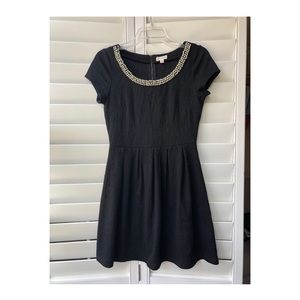 Short black dress with beaded neckline